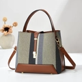Striped patchwork knit bucket bag with brown leather handles and a gold buckle detail - Green