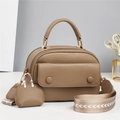 Close-up of khaki pebbled leather handbag with wide geometric strap and mini charm - Khaki