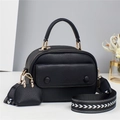 Black lychee leather handbag with wide geometric strap and mini decorative charm pouch - Black