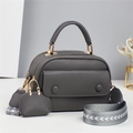 Detail of dark grey litchi grain leather crossbody bag with jacquard woven strap - Gray