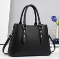 Elegant black lychee grain leather handbag with gold rivets and detachable shoulder strap - Black