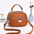 Detail of brown multi-zip handbag showing lychee texture and silver hardware accents - L22 W11 H16 / Earthy Yellow