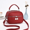 Red lychee textured leather handbag with three zipper compartments and adjustable strap - L22 W11 H16 / Wine Red