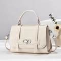Litchi pattern cream handbag with silver buckle on minimalist stone pedestal - Off White