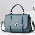 Detailed close-up of grey-blue litchi grain leather bag with golden Dior-style buckle - Blue