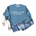 Flat lay of blue sweatshirt with 'I closed my book to be here' text and denim jeans - S / Blue (White Font)