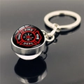 Nahaufnahme eines silbernen Feuerwehr-Schlüsselanhängers mit Glasdom und Logo-Motiv - Feuerwehr Rot Schwarz Schild (XSWX2244-4)