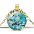 Detailed macro of a dolphin time gem pendant with blue ocean glass and bronze chain - Dolphin Pattern (XSWX3529-6)