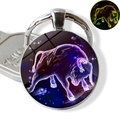 Luminous Taurus zodiac keychain with blue starry sky glass pendant and glow effect - Taurus