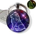 Detailed macro of Leo zodiac sign glowing glass pendant with silver keychain - Leo