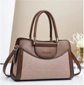 Detail of color-block tote bag featuring brown leather and woven texture with gold hardware - Pink