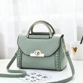 Elegant mint green leather crossbody bag with woven side detail and gold metal handle - Mint Green