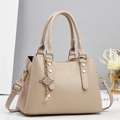 Striped beige leather handbag with gold hardware and elegant metal pendant charm - L28 W13 H20 / Khaki