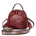 Detail of burgundy pebbled leather backpack with a colorful striped detachable strap - Wine Red