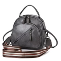 Detail of dark grey PU leather handbag with adjustable striped fabric shoulder strap - Gray