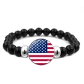 Beaded bracelet with black stones and round US flag glass pendant on white background - United States