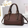 Close-up of deep brown litchi grain leather bag with golden hardware and handles - L26cmxW13cmxH15cm / Coffee