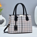 Detail of elegant plaid tote bag featuring golden hardware and detachable shoulder strap - Black Grid