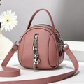 Pink round crossbody bag with tassels, multi-layer zippers and lychee grain texture - 17x8x18 / Dusky Pink