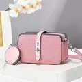Pink and white woven crossbody bag with matching round coin purse on a minimalist desk - Pink