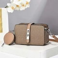 Detailed shot of khaki textured crossbody bag with matching round coin purse and silver lock - Khaki