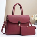 Close-up of deep red pebbled leather handbag set with metal twist lock and small pouch - Red
