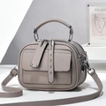 Detail of grey lychee leather handbag with three zipper compartments and silver hardware - Light Gray