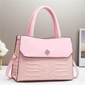 Pink crocodile-embossed handbag with gold floral clasp and adjustable shoulder strap - Large / Pink
