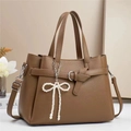 Detail of brown litchi grain leather tote with white pearl bow charm and silver buckle - L29 W13 H22cm / Khaki