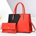 Detail of red and black color-block tote bag set with golden hardware and matching pouch - Red