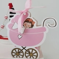 Detailed view of a pink baby carriage gift box with silk bow and cartoon illustration - Pink