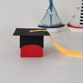 European style graduation cap gift box with red ribbon and yellow tassel detail - Red