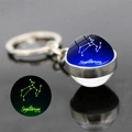 Luminous Sagittarius glass ball keychain with silver metal ring and glow effect - Sagittarius