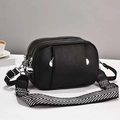Black pebbled leather crossbody bag with three zippers and a wide geometric strap - 24x10x16cm / Black