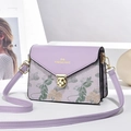 Detail of lavender purple crossbody bag featuring floral embroidery and gold metal lock - Taro Purple
