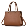 Detailed view of brown litchi grain leather handbag with gold Fashion & Bag lettering - 28x12x22cm / Earthy Yellow