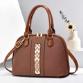 Detail of a brown Boston bag showing geometric color-block stripes and gold hardware - Earthy Yellow