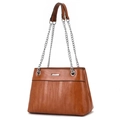 Detail of caramel striped crossbody bag featuring textured pattern and silver chain strap - Earthy Yellow