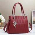 Detail of wine red handbag with geometric texture and pearl star pendant detail - Red
