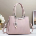 Detalle de bolso de piel rosa grabado con colgante de perlas de estrella y luna - Rosa