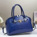 Dark blue crocodile pattern handbag with gold lock and handles on a white display stand - 29cmx13cmx22cm / Blue