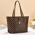 Detail of checkered bucket bag with leather strap and decorative brand tag on a desk - Checkerboard Coffee