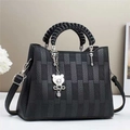 Black multilayer shoulder bag with checkerboard panel, woven handle and bear charm - Black