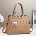 Detail of tan leather crossbody bag featuring lychee texture and silver bear charm - L25 W11 H19 / Khaki