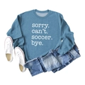 Flat lay of blue sweatshirt with 'Sorry Can't Soccer Bye' text and denim shorts outfit - Blue (White Font)