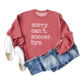 Flat lay of red soccer slogan sweatshirt with white sneakers and denim shorts - Red (White Font)