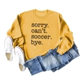 Detail of yellow sweatshirt with Sorry Can't Soccer Bye text and denim styling - Yellow (Black Font)