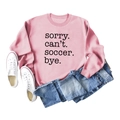 Flat lay of pink sweatshirt with 'Sorry Can't Soccer Bye' print and blue jeans - Pink (Black Font)