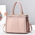 Detail of light pink tote bag featuring lychee grain leather and vertical striped embossing - Pink