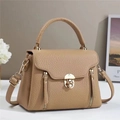 Detail of khaki pebbled leather handbag with gold metal lock and decorative zippers - Khaki